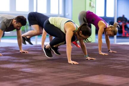 The group performs barpie exercises